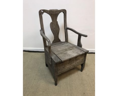 A circa 1800 Provincial walnut and oak commode armchair with box seat, raised on shaped supports, 62 cm wide x 101.5 cm high