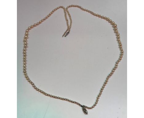 A two strand graduated pearl necklace, the navette form clasp with central small diamond (approx 0.03 carat), 46.5 cm long ov