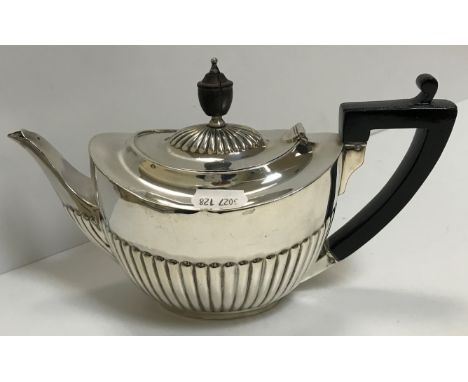 A Victorian silver oval teapot with semi-reeded decoration, ebony finial and ebonised handle, bearing lion mask armorial (by 