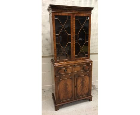 A Bevan Funnell Reprodux mahogany secretaire bookcase with two glazed doors over a fitted drawer and two cupboard doors on br