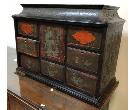 An 18th Century Boulle work tabletop cabinet, the caddy top with secret rising lid over a central door within a bank of seven