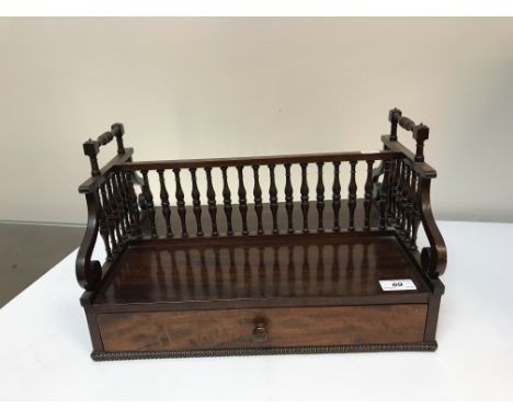 An early Victorian mahogany double sided book trough with drawer to one side and turned gallery to centre, approx 42 cm long 