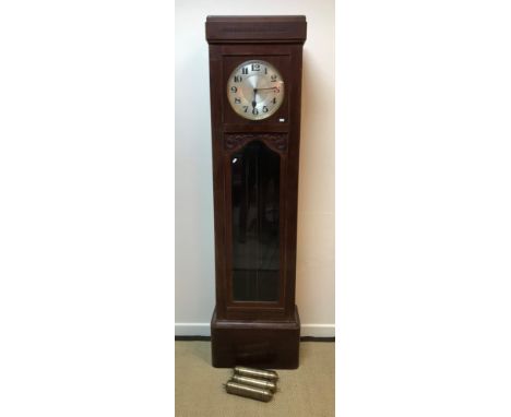 A 1930's mahogany cased long case clock, the musical movement with circular silvered dial and Arabic numerals, 49 cm wide x 2