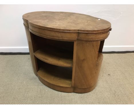 A 1930's walnut Art Deco "Cloud" table, the quartered top above two side slides and open side shelves, the front and back wit