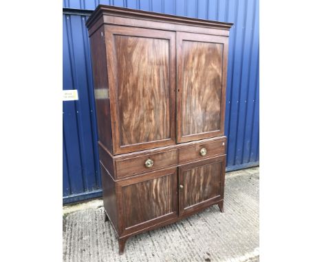 A late Regency mahogany linen press, the upper section with two panelled doors enclosing four linen shelves over two drawers 