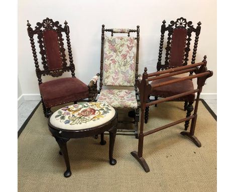 A pair of Carolean style carved oak dining chairs on bobbin supports with upholstered back panel and seat, 42.5 cm wide x 102