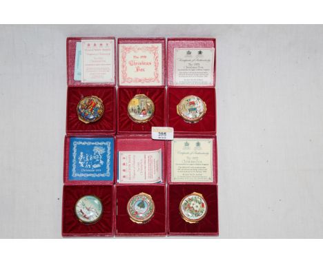 A group of six Halcyon Days Bilston enamel Christmas design boxes, each retaining their original boxes and certificates. COND