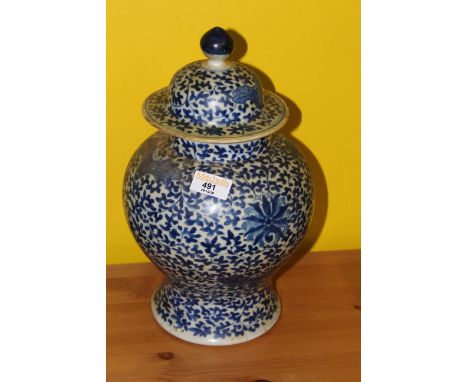 A late 18th/early 19th century Chinese blue and white baluster vase and cover, the domed finial topped cover and baluster bod