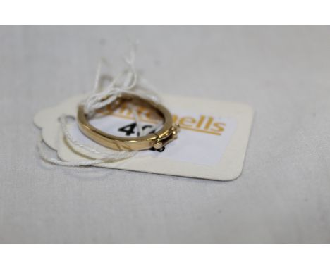 A yellow metal thought to be gold cravat or scarf ring, hinged at the centre with a safety clasp, 2 cm &amp; 2 grams in total