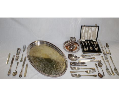 A selection of various silver plated wares, including three oval trays, a chamber stick and a selection of flat ware, nut cra