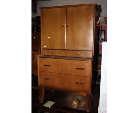 A mid century teak dressing table/cabinet by Wrighton, upper part fitted, adjustable mirror and electric lights, base with sl