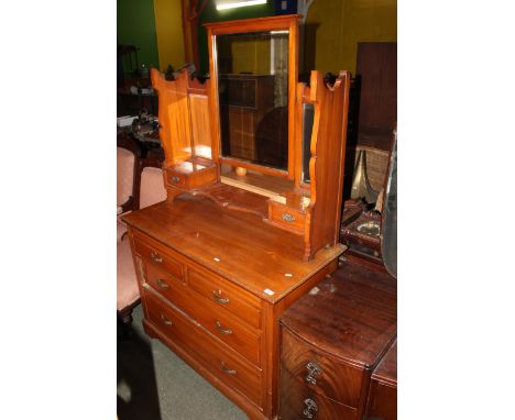 An Edwardian walnut dressing chest, superstructure with central bevelled rectangular mirror plates and flanking smaller plate
