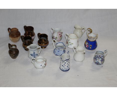 A group of fifteen 19th century milk jugs, various moulded shapes and designs to include copper lustre, a Doulton Lambeth sto