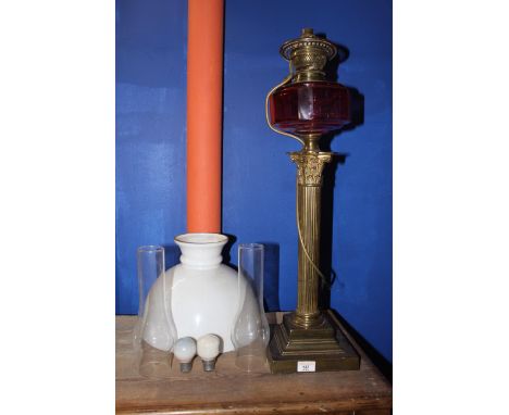 A Victorian silver plated Corinthian column pattern table oil lamp with cranberry glass faceted reservoir and cylindrical sec