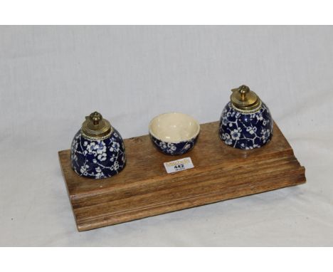 A Victorian oak desk stand with two cobalt blue and prunus decorated pottery inkwells and a ditto mixing bowl.  the rectangul