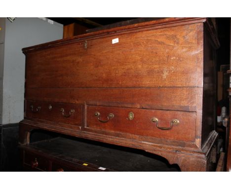 An 18th century oak mule chest, fitted two drawers on bracket feet, 145 cm wide x 44 cm deep x 69 cm high.  CONDITION REPORT: