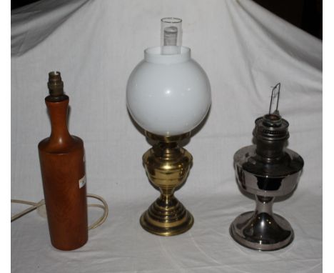 A turned word bottle form electric table lamp, 42 cm high, an Aladdin chromed metal table oil lamp and a brass table oil lamp