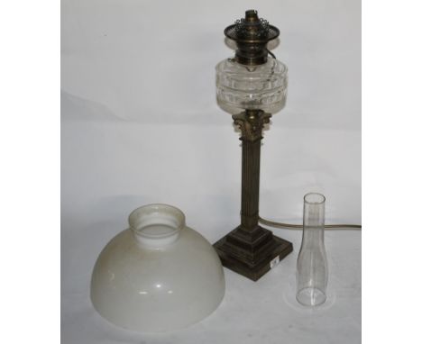 A Victorian parcel gilt Corinthian column pattern table oil lamp with cut glass faceted reservoir and square section column, 
