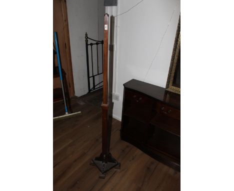 A mahogany standard lamp with square section form with central moulded knop, the base with 4 shaped brackets and square platf