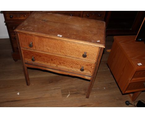A 1940's light oak utility chest, with moulded rectangular top over 2 drawers and enclosed by reeded supports, 75 cm x 75 cm 