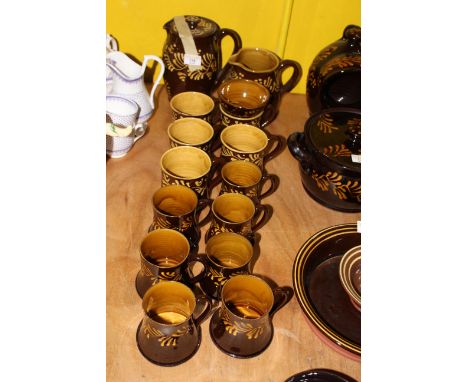 A Wetheriggs brown and yellow trailed glazed pottery part tea/coffee service, comprising lidded hot water jug, milk jug, suga