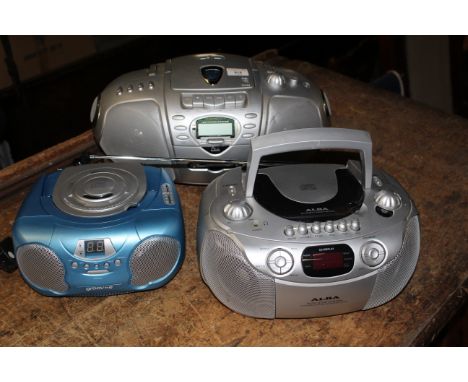 A Goodmans cd/radio and cassette player, an Alba ditto and one other cd player. CONDITION REPORT: The blue cd player in this 