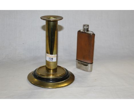 A 19th century brass cylindrical candlestick of plain design, the foot rim inset with black vulcanite style ring, 19 cm high 