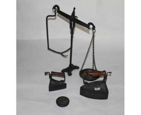 A Victorian cast box smoothing iron with turned wood handle, 19 cm high, a similar smaller ditto, 13 cm high and a pair of Vi
