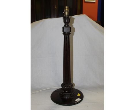 A mahogany reeded column table lamp with petal carved collars and a circular base, 50 cm to fitting. CONDITION REPORT: A smal