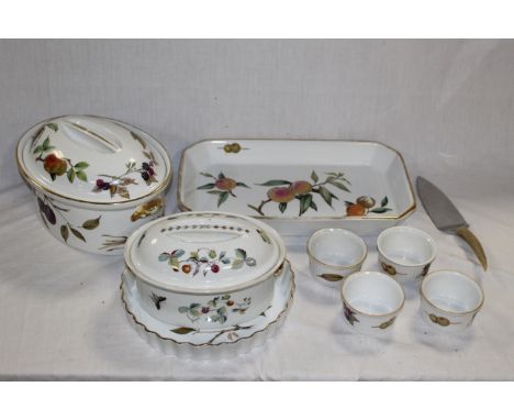 A Royal Worcester Evesham pattern oval tureen and cover, a circular flan dish and a canted rectangular dish, two ramekins and