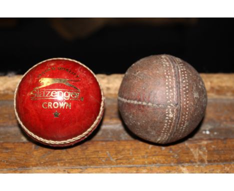 A Vintage stitched leather cricket ball and a Slazenger crown stitched red leather cricket ball. CONDITION REPORT: Vintage ba