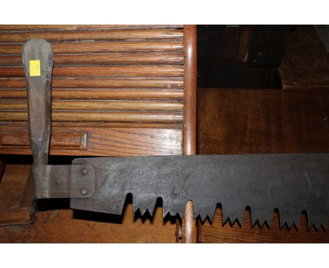 A vintage two man 5ft cross cut saw. CONDITION REPORT: The blade of the saw has light rusting throughout but does appear othe