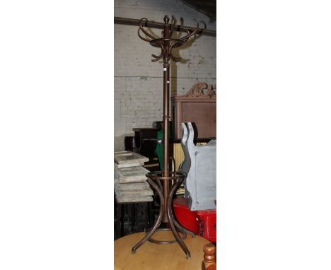 A modern bentwood coat stand, having a crown of 6 scrolled hooks above the turned column with circular stick stand to base on