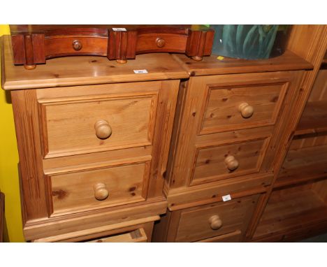 A pair of modern pine bedside chests having a moulded rectangular top above 2 moulded panelled drawers and between fluted col