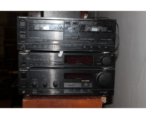 A Technics stacking music system - stereo double cassette deck and stereo tuner and integrated amplifier, together with two T