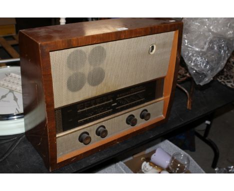 A vintage walnut framed Murphy radio with material speaker grill, 42 x 52 x 16 cm. CONDITION REPORT: Some marks and scratches
