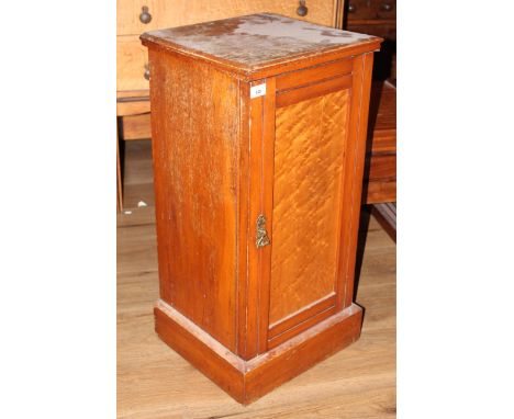 A Victorian satinwood and birds eye maple pot cupboard, having a moulded top above a birds eye maple panelled door enclosing 