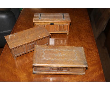 Three mid 20th century oak "coffer form" jewellery boxes, a similar trunk form ditto, three white metal oval lidded trinket b