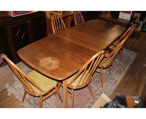 An Ercol light elm extending dining table fitted single folding leaf on square angled legs, 220 x 85 x 73 cm high and a set o