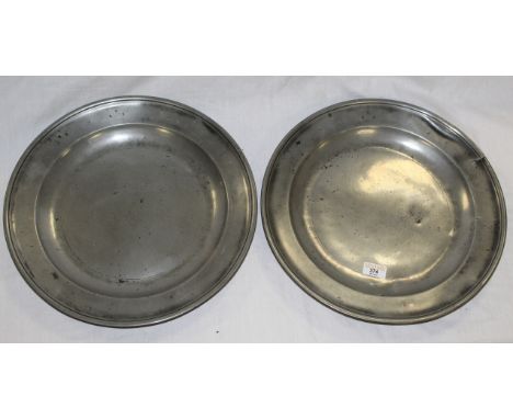 Two 18th century pewter chargers with rolled rims and dished centre, initial stamps H R E. No obvious touch marks to base. 38