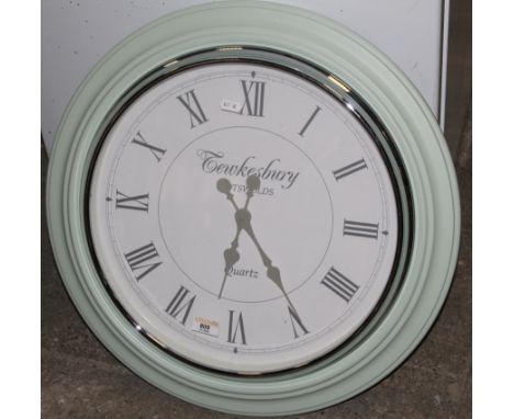 A Tewkesbury Cotswolds pale green metal quartz kitchen clock, with white dial, 54 cm diameter and a cream painted  electric t