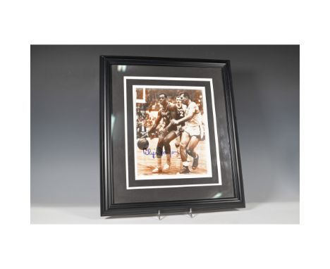 A striking sepia-toned action photograph featuring Elgin Baylor, the legendary Los Angeles Lakers forward, signed boldly in b
