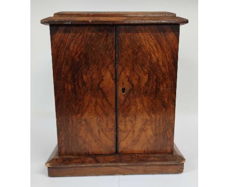 A Victorian Walnut Table Cabinet, late 19th century, the caddy top over two doors enclosing three drawers, on a chamfered pli