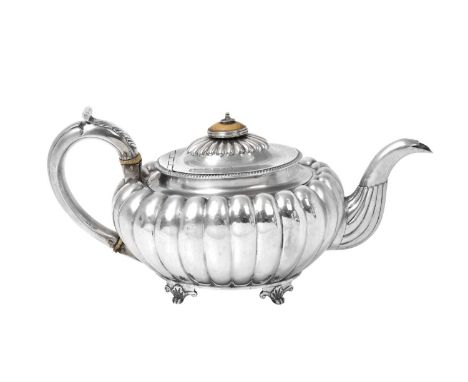 A George III Silver Teapot,   by Charles Hollinshed, London, 1807 oval and on four scroll and shell-cast feet, the sides lobe