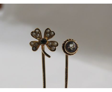 Gold stick pin with terminal modelled as a four-leaf clover and set with twelve seed pearls and a small green stone centrally