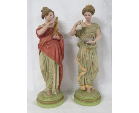 Two corresponding Robinson and Leadbeater Parian ware figures of Classical ladies, polychrome with gilding, the first in gree