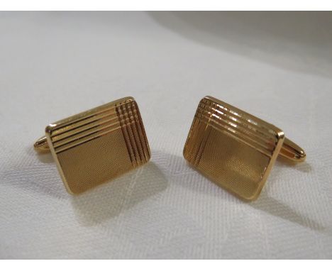 Pair of yellow metal cufflinks with rectangular engine turned faces, stamped 750, 8.7g