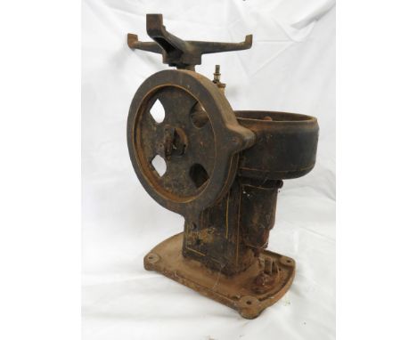 A cast metal item of equipment with turning handle marked 60 T. PR. MIN, oil reservoir, geared wheel and three-prong stand, h