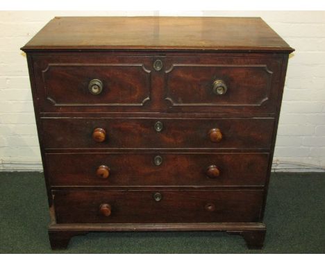 A Georgian mahogany secretaire chest of four drawers on bracket feet. The secretaire drawer reveals two nests of three drawer