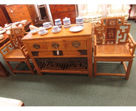A far Eastern light wood sideboard with three short drawers to top and slatted under tier, with carved hardwood panels and ap
